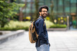 © Prostock-studio - Cool young hindu guy with backpack walking by street