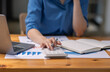 © David - Asian Business woman using calculator and laptop for doing math finance on an office desk, tax, report, accounting, statistics, and analytical research concept