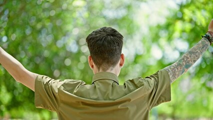 Sticker - Young hispanic man doing yoga exercise backwards at park