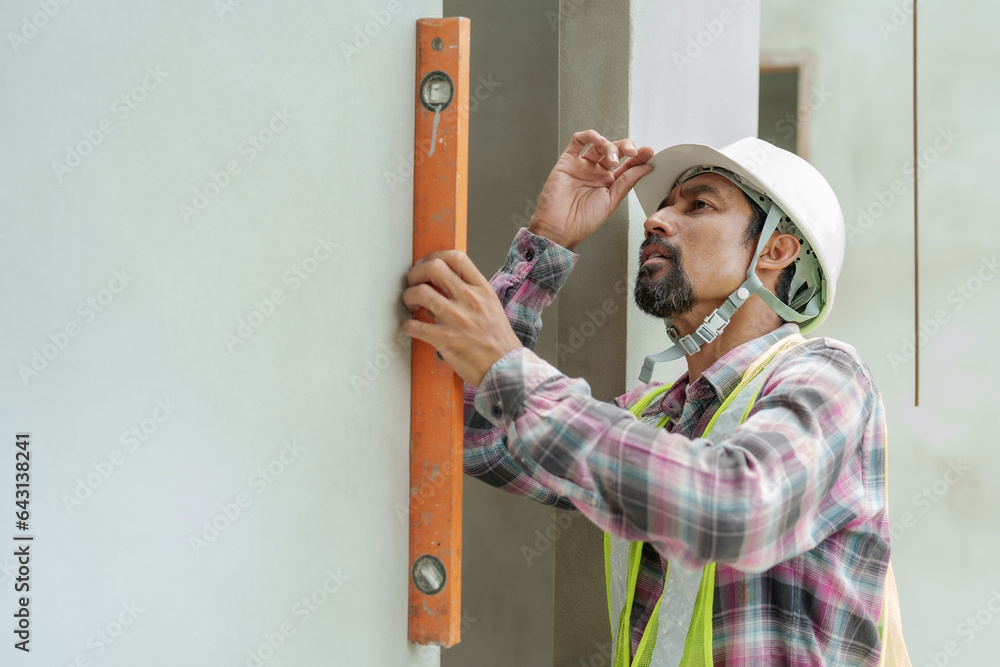 Indian construction engineer with mustache using water level meter ...