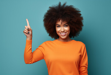 Wall Mural - Black woman over isolated green background pointing finger