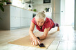 © Marko Geber - Senior caucasian woman planking and exercising at home