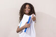 © Tatiane Silva - Portrait of a student girl showing her excitement for going to school. Girl gesturing thumbs up.