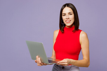 young smiling happy cheerful it woman she wears red tank shirt casual clothes hold use work on lapto