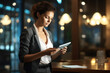 © vefimov - Woman in business suit is seen looking at tablet. This image can be used to represent technology, business, and modern work environments.