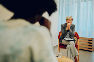 Wall Mural - A female psychotherapist is talking to a crying woman with problems.