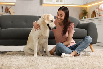 Sticker - Happy woman with cute Labrador Retriever dog on floor at home. Adorable pet