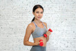 © Art_Photo - Portrait of sport slim fit strength woman workout in sportswear sitting relax and do fitness exercise with dumbbell on white background.Diet concept.Fitness and healthy lifestyle