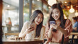 © Kyohei Kaneko - カフェで友達とスマホを見て笑う女性 Girls talking looking at smartphone in cafe