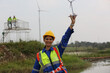 © FotoArtist - Engineer in protective workwear and windturbines on the background. Concept of alternative energy and its maintenance