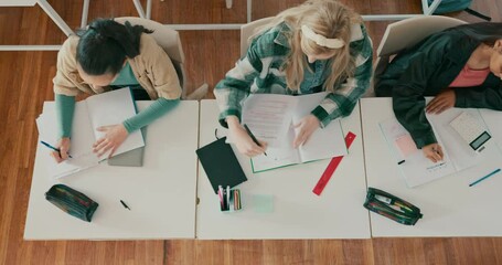 Poster - School, above and students writing in classroom for examination, assessment and test on desk. Education, academy and top view of teenagers write on paper for notes in lesson, learning and knowledge