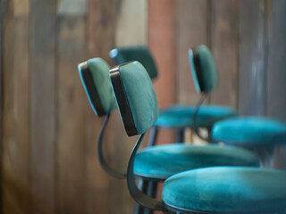 High stools aligned in front of the counter of a restaurant