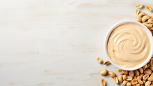 Bowl Of Peanut Butter And Peanuts On Table Background
