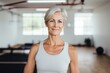 © radekcho - Mature woman standing in a fitness studio.