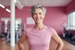© radekcho - Mature woman standing in a fitness studio.