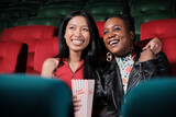 Fototapeta Dziecięca - Couple of Black female audiences and lovers express emotion, watching funny cinema together, laughing at movie theater, and entertaining lifestyle with romance film show with happy and cheerful smile.