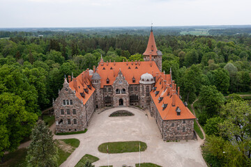 Wall Mural - Cesvaine medieval castle in Latvia from above. Building of stones with a brown tiled roof.