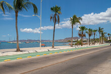 A Beautiful Sunny Morning In The Peaceful Malecon Of La Paz, Capital City Of The State Of Baja California Sur. Mexico. Under A Cloudy And Blue Sky