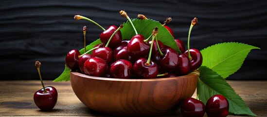 Fototapete - Cherries and leaves in wooden bowl on rustic background