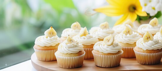 Leinwandbilder - Delicious looking banana cupcakes on wood plate with flowers vintage tone copy space