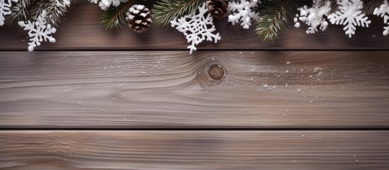 Poster - Top view of a snowy branch on a Christmas themed wooden background with space for text
