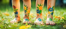 Smiling Children S Patterned Feet On Green Grass With Selective Nature Focus