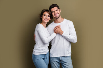 Wall Mural - Photo of positive sweet hugging couple wear white clothes enjoy time together anniversary honeymoon isolated on brown color background