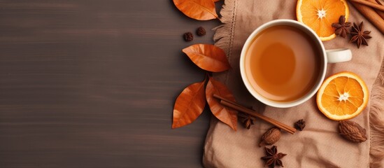 Poster - Flat lay composition in autumn or winter with a coffee cup dry leaves and dried orange on a linen fabric background Copy space available representing autumn or fall