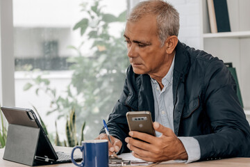 Wall Mural - mature businessman working in the office