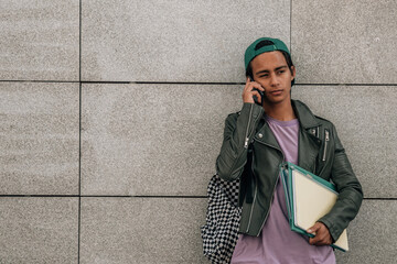 Wall Mural - teenage student talking on the phone on the street