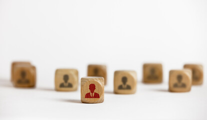 red man icon on a wooden block in front and the black man icon on the wooden block in front is blurred. Ideas to showcase business leadership influence and power for leadership teams. Successful conte