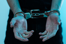 Male Hands In Handcuffs Black Background