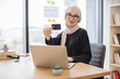 © Sofiia Shunkina - Arabian female with credit card running laptop in workplace