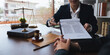 © Natee Meepian - Home loan insurance, Male lawyer or judge Consult with client and working with report the case on table in office, Law and justice concept