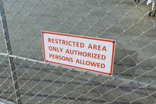 Restricted Area. Only authorized persons allowed sign on the airport fence