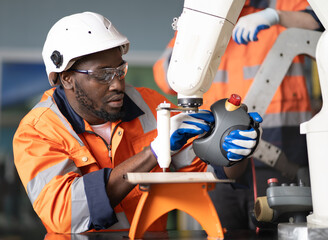 Industrial engineer inspecting mechanic part of robot structure frame in automation factory. Professional robotic and electronic technician working in manufacturing with futuristic innovation machine.