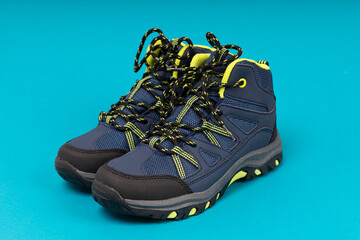 Wall Mural - Man's winter mountain boots on blue background