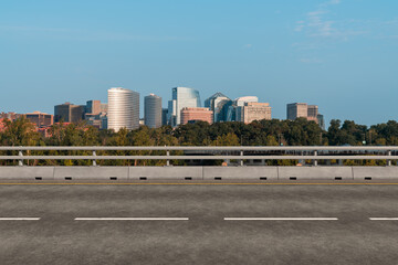 Empty urban asphalt road exterior with city buildings background. New modern highway concrete construction. Concept way to success. Transportation logistic industry fast delivery. Arlington. USA.