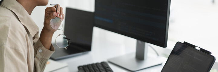 Wall Mural - developer programmer working to checking code on monitor while programming to developing website