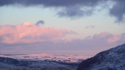 Wall Mural - Dawn weather with pink light on snowy British mountains