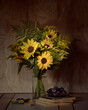 Still life with a bouquet of sunflowers and plums