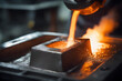 © Mikhail - Close-up view of molten metal being poured into molds in a foundry
