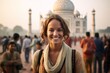 © Markus Schröder - Environmental portrait photography of a grinning girl in her 30s wearing an ornate brooch in front of the taj mahal in agra india. With generative AI technology