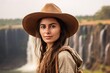 © Markus Schröder - Medium shot portrait photography of a glad girl in her 20s wearing a rugged cowboy hat at the victoria falls in livingstone zambia. With generative AI technology