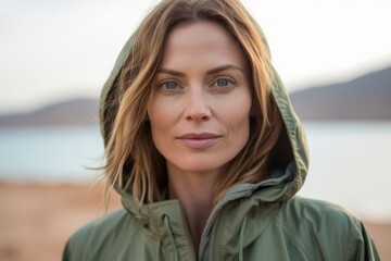 Wall Mural - Close-up portrait photography of a content girl in her 40s wearing a functional windbreaker at the dead sea in israel/jordan. With generative AI technology