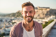 Headshot Portrait Photography Of A Grinning Boy In His 30s Wearing A Trendy Cropped Top In Front Of The Acropolis In Athens Greece. With Generative AI Technology