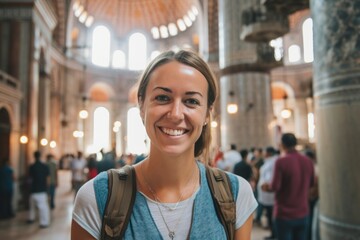 Wall Mural - Close-up portrait photography of a happy girl in her 30s wearing a breathable mesh vest at the blue mosque in istanbul turkey. With generative AI technology