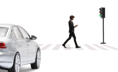 Sticker - African american young businessman in a suit and tie walking and using a smartphone at a pedestrian crosswalk