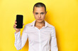 © Asier - Woman with shaved head showing phone screen, serious expression