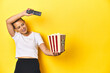 © Asier - Woman with popcorn and TV remote, home cinema concept